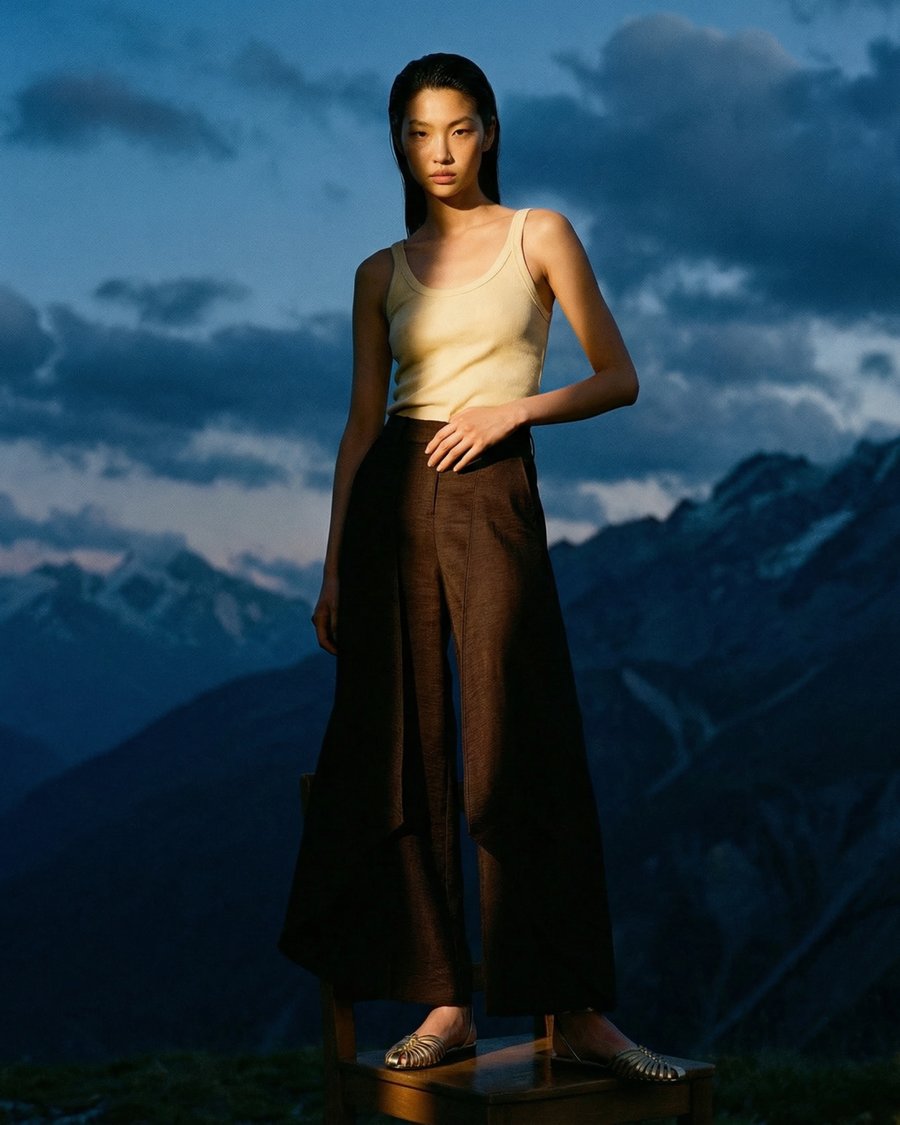 Model in tank top, mountain backdrop, full body