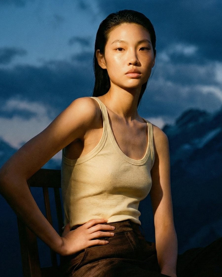 Model in tank top, mountain backdrop, portrait